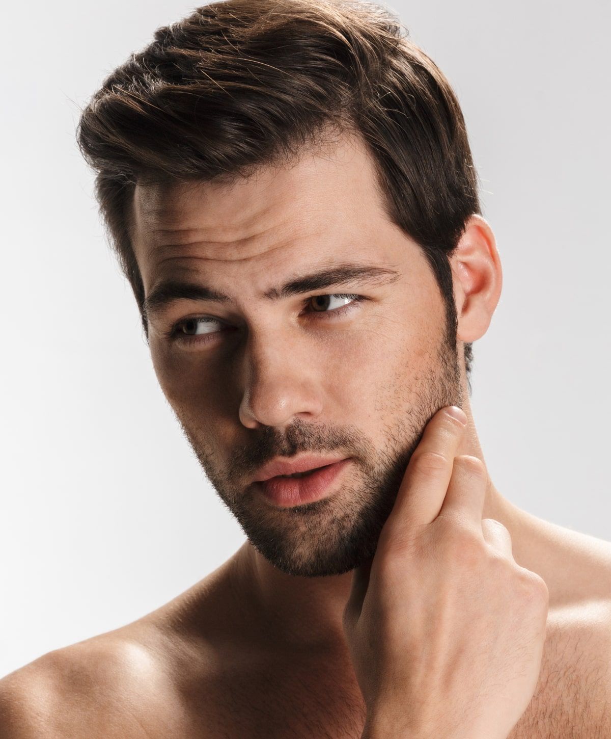 Charlotte Exosome Hair Therapy model touching his chin, thoughtful expression.