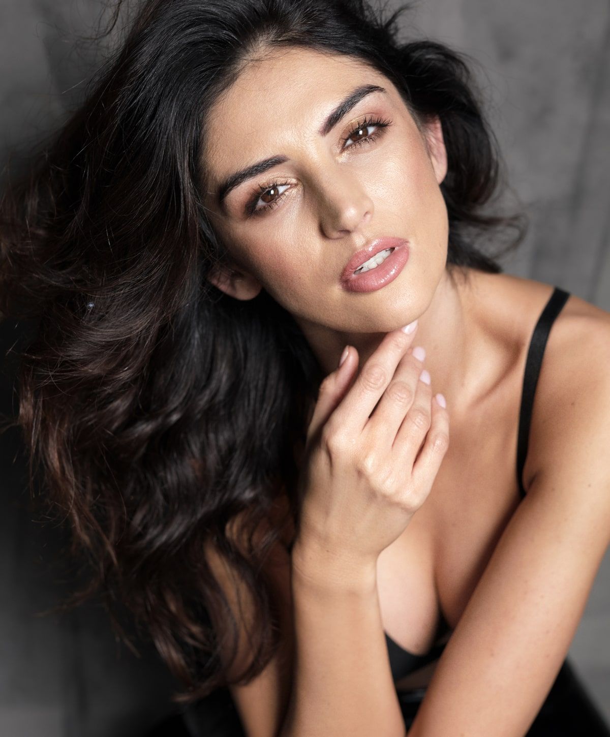 Woman with flowing hair and a soft expression.