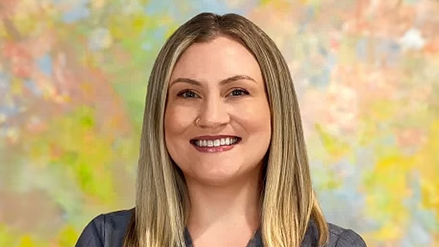 Smiling woman with long hair and colorful background